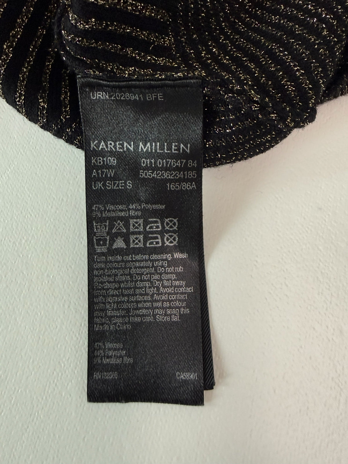Style Reset Karen Millen black and gold metallic knit garment care label with washing instructions