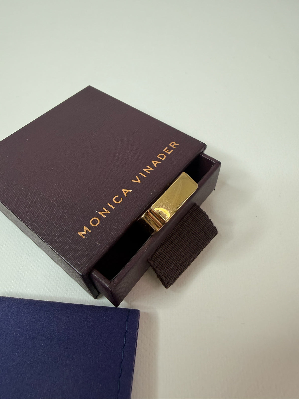 Style Reset gold-tone Monica Vinader designer ring inside a premium branded purple jewellery box