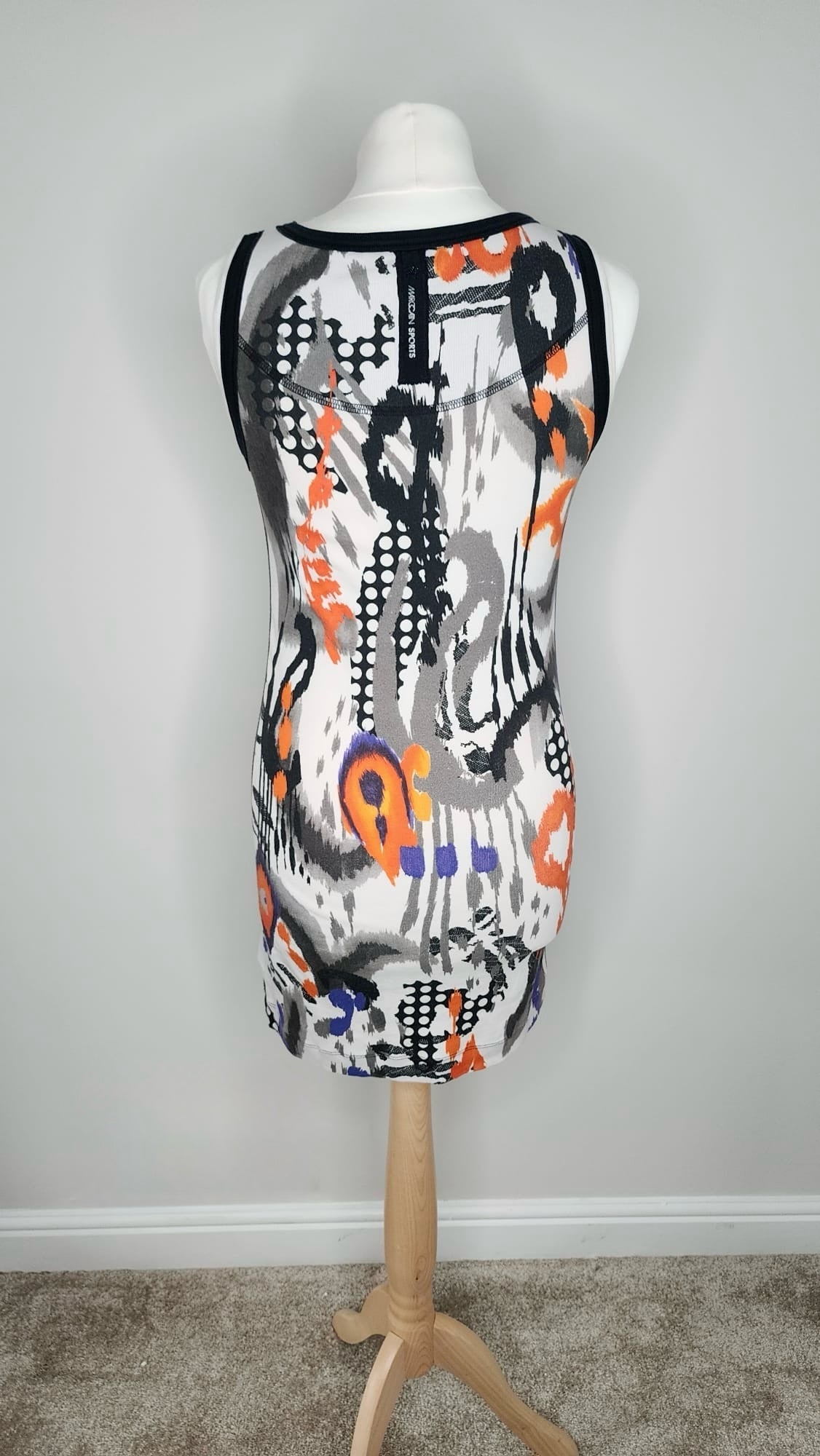 Style Reset sleeveless mini dress with abstract orange, purple, and black print on a white cotton-blend ribbed fabric.