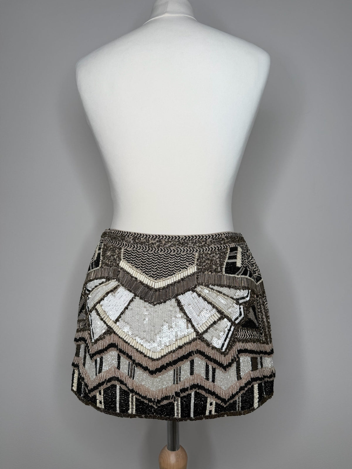 Style Reset AllSaints mini skirt featuring intricate black, cream, and bronze geometric sequin and bead embellishments.
