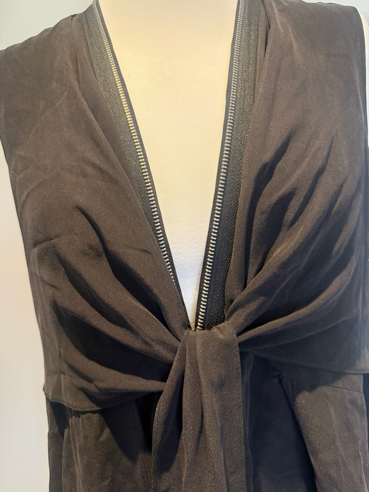 Style Reset AllSaints black silk midi dress featuring a sleeveless design, front zip detail, and a cinched tie front.