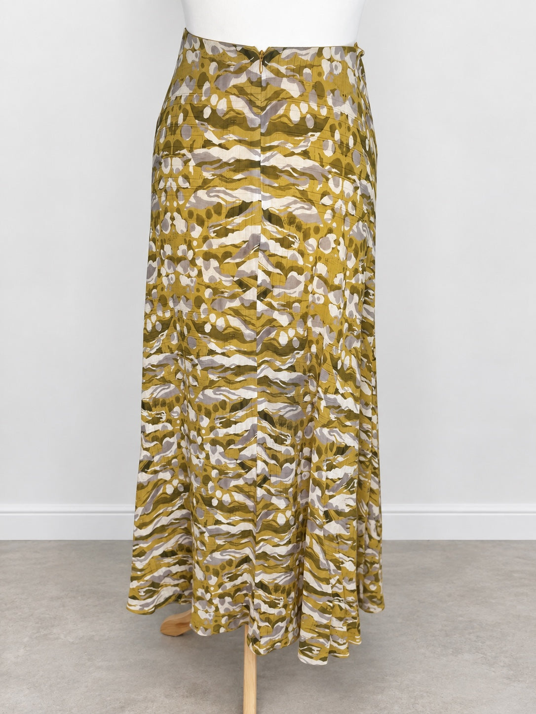 Style Reset ALLSAINTS maxi skirt in olive, mustard, and grey abstract camouflage print with a fluid high-low hemline.