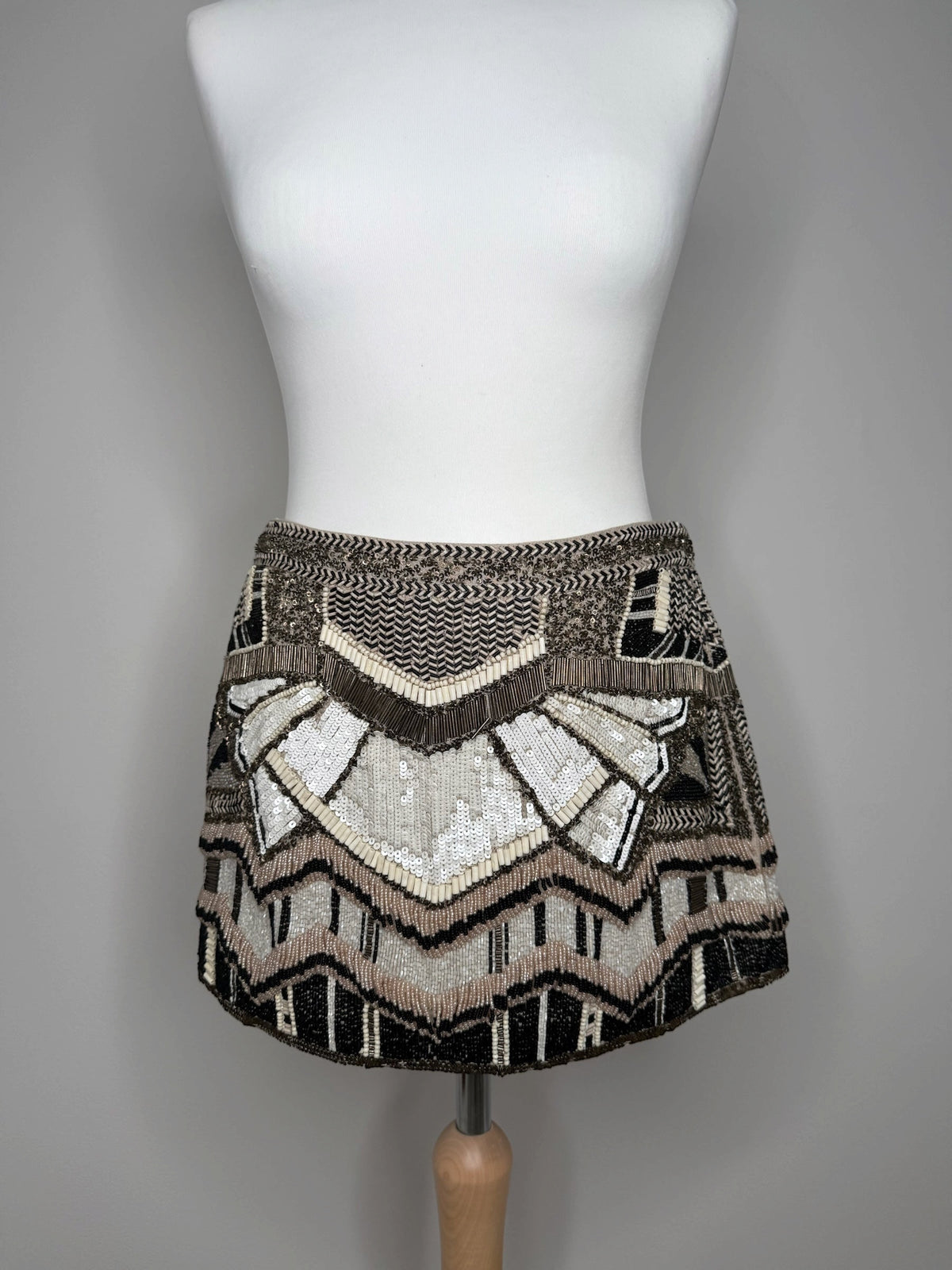 Style Reset AllSaints mini skirt featuring intricate black, cream, and bronze geometric sequin and bead embellishments.