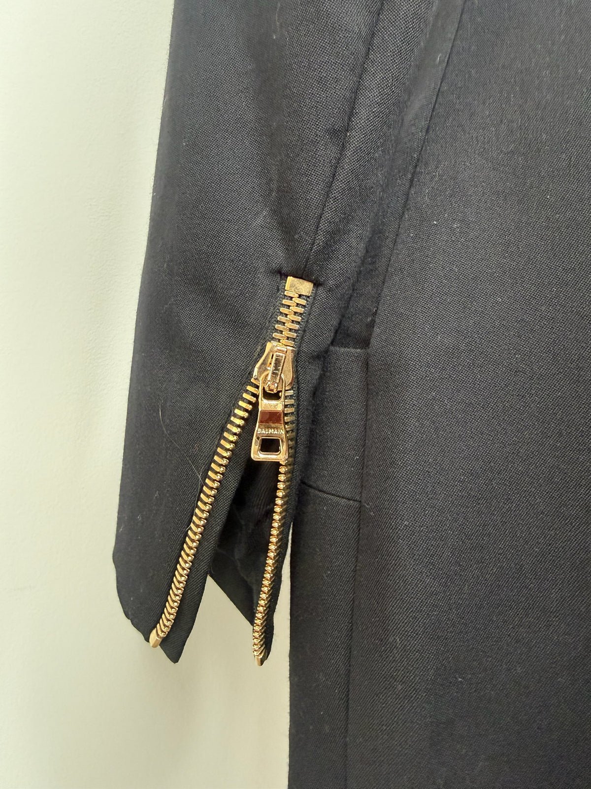 Style Reset black Balmain mini dress sleeve featuring a polished gold-tone zip detail on the cuff