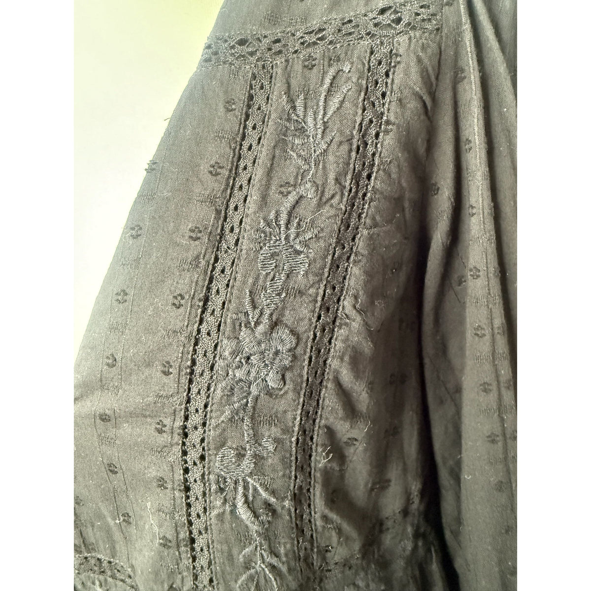 Style Reset black mini dress featuring intricate floral embroidery and delicate lace-style trim on textured fabric.