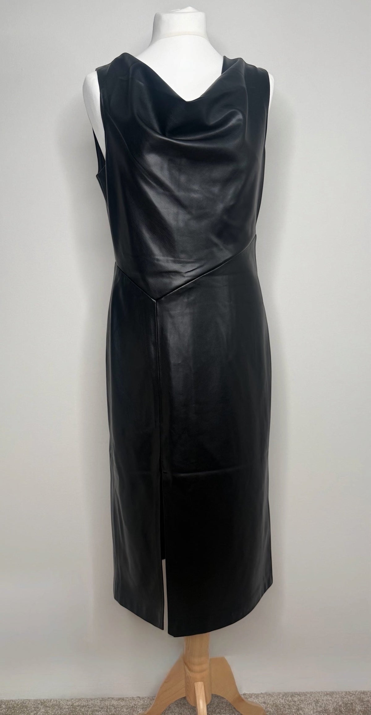 Style Reset black faux leather midi dress with a sleeveless cowl neck and front split hem on a mannequin