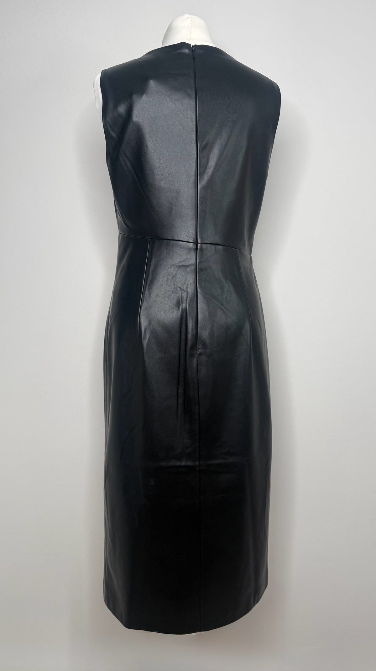 Back view of a Style Reset black sleeveless faux leather midi dress with a central zip fastening.