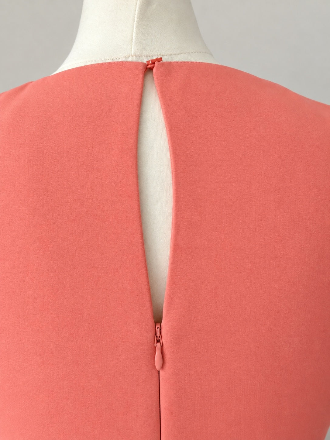 Style Reset coral sleeveless midi dress featuring a round neckline with a back keyhole and discreet zip fastening.