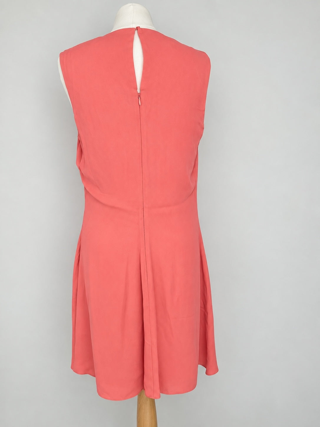 Style Reset coral sleeveless midi dress featuring a round neckline and a back keyhole with zip fastening