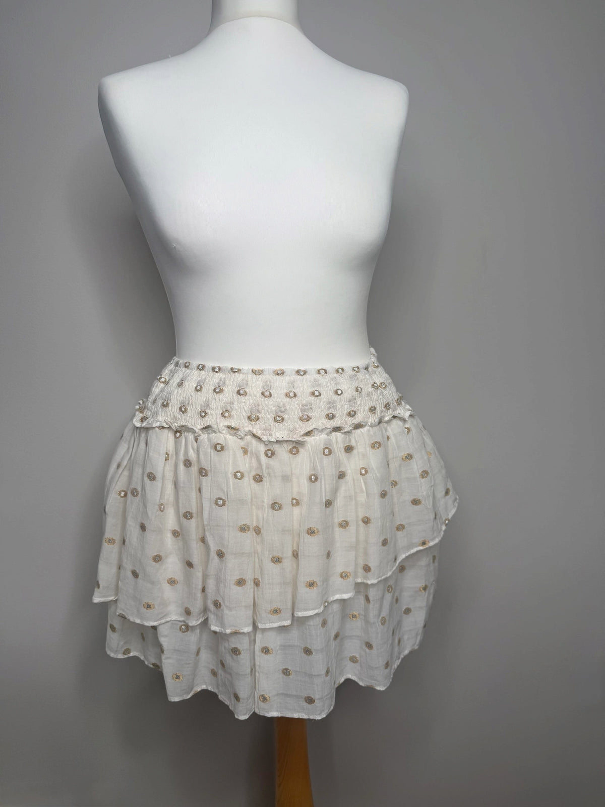 Style Reset cream tiered mini skirt with gold and silver metallic dot embroidery and a shirred elasticated waistband.