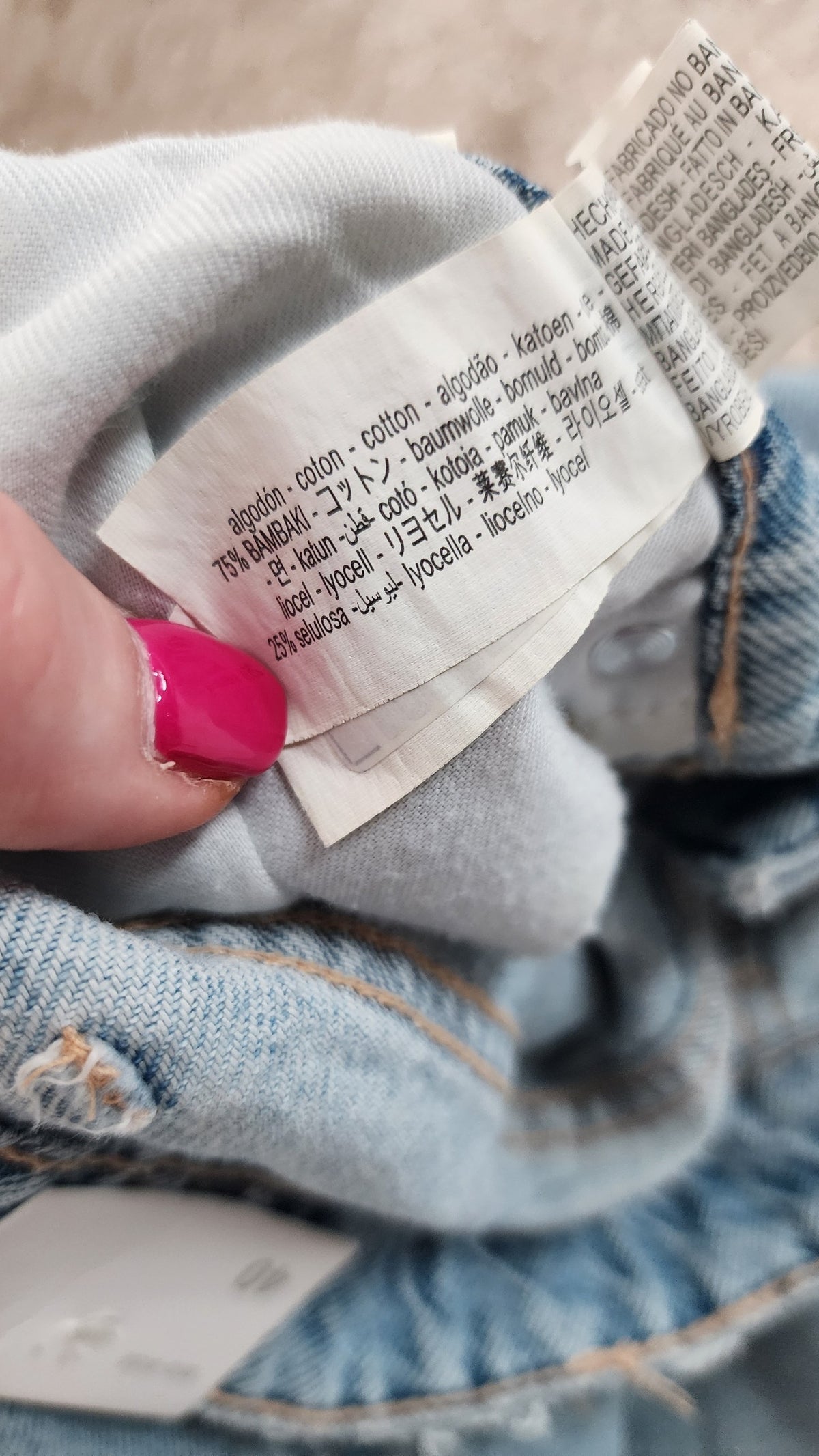 Style Reset denim shorts care label showing 75% cotton and 25% lyocell fabric composition