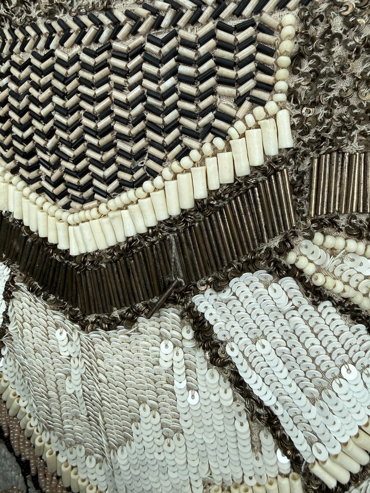 Close-up of Style Reset hand-embellished mini skirt featuring intricate black, cream, and bronze bead and sequin detail.
