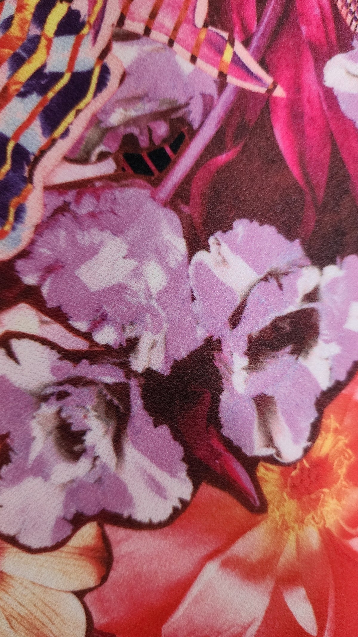 Style Reset sleeveless mini dress fabric featuring a vibrant abstract floral print in orange, pink, and deep purple.