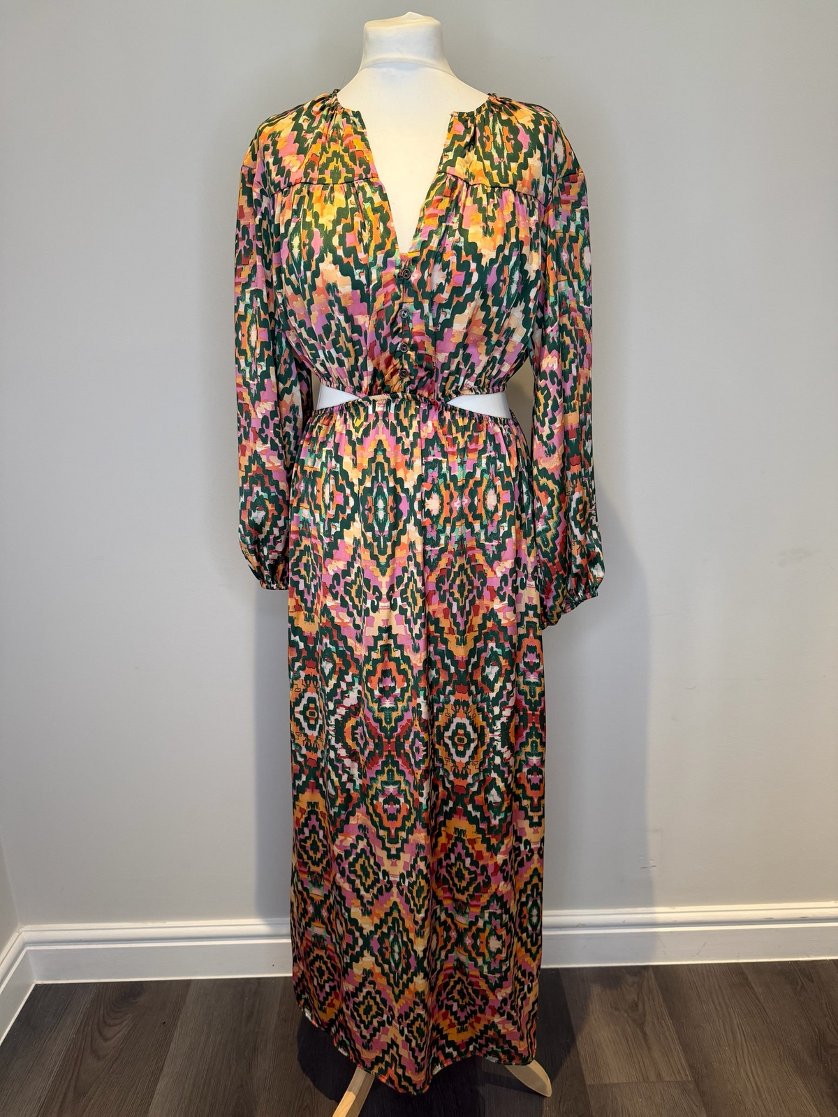Style Reset long sleeve maxi dress in a vibrant multi-coloured geometric print with a chic cut-out waist detail.