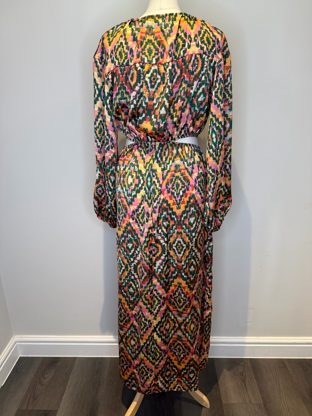 Style Reset long sleeve maxi dress with a vibrant geometric print in green, orange, and pink featuring a cut-out waist