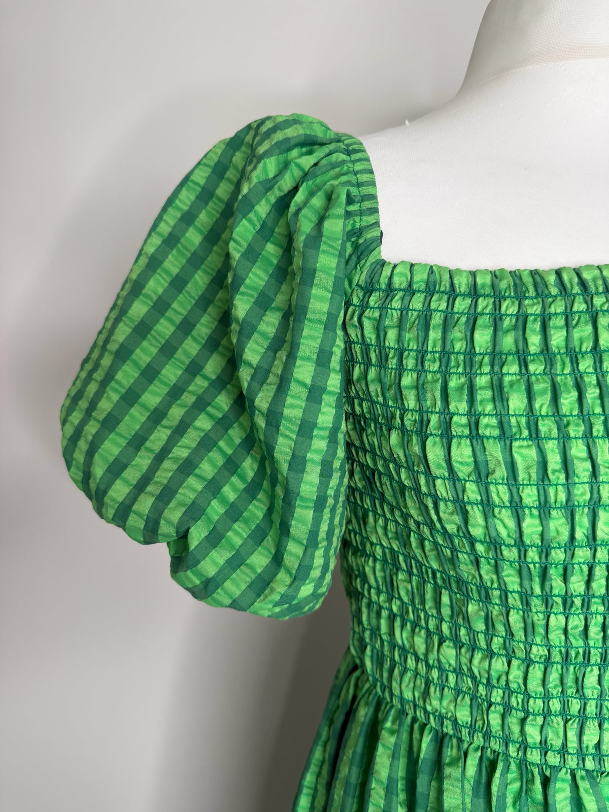 Style Reset green gingham midi dress with a square neckline, shirred bodice, and dramatic puff sleeves.