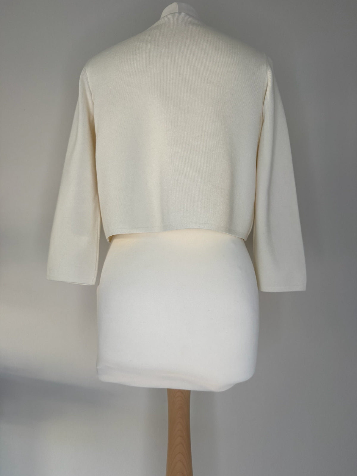 Style Reset HOBBS LONDON cream cropped knit cardigan with three-quarter sleeves on a mannequin, back view.