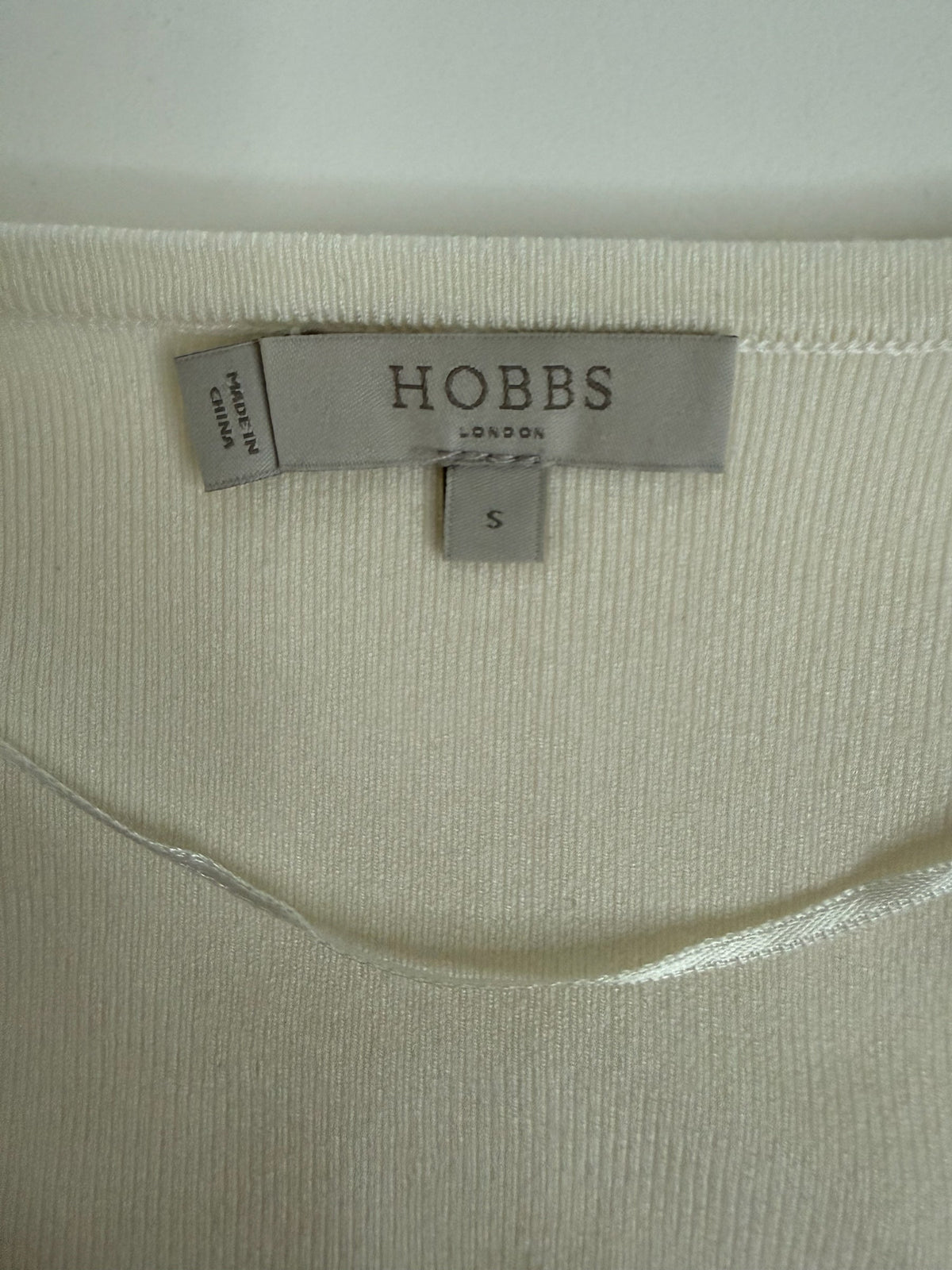 Style Reset Hobbs London cream knit cardigan label showing size small and fabric texture
