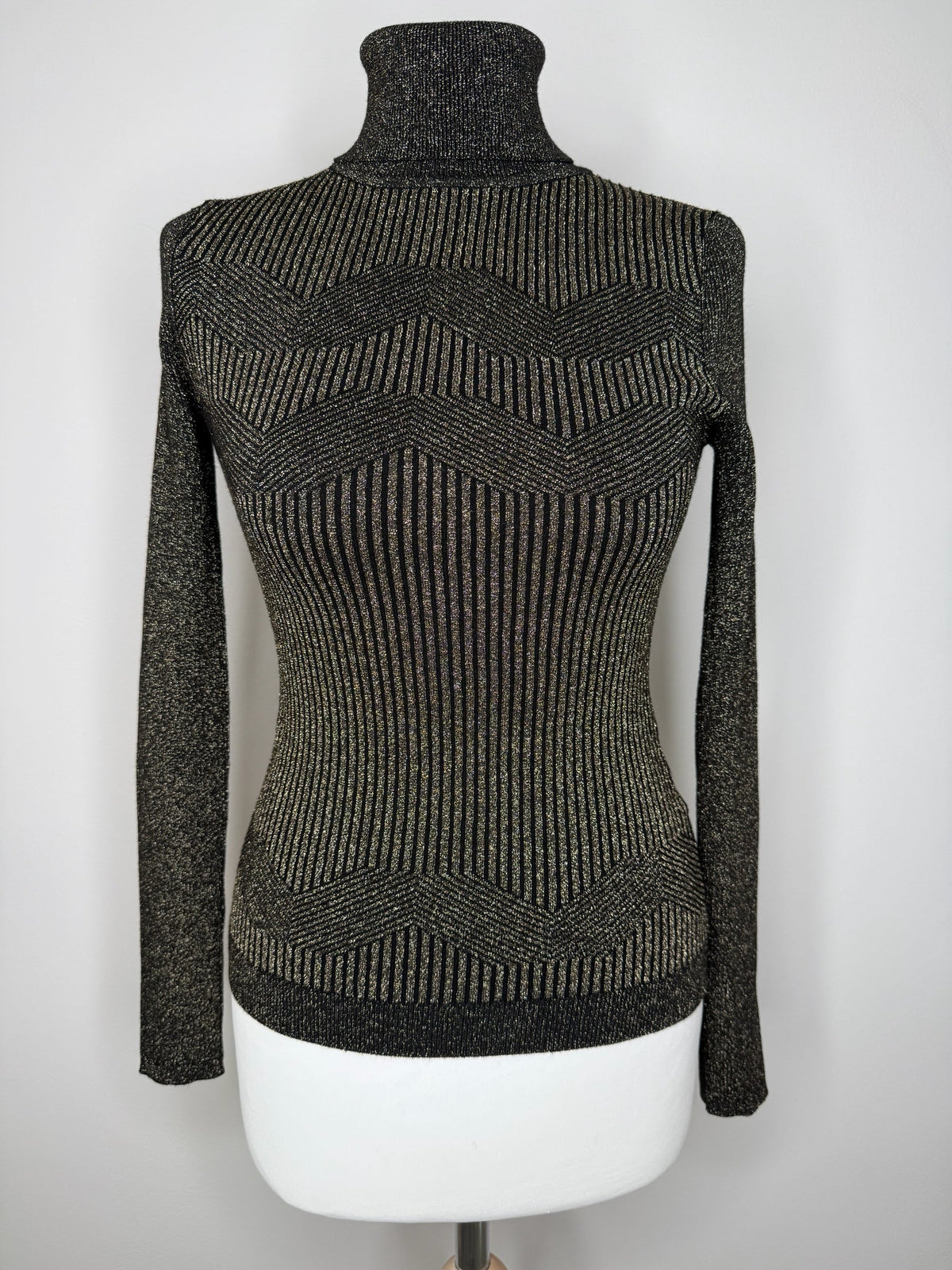 Style Reset Karen Millen black and gold metallic turtleneck knit top with geometric ribbed texture on a mannequin.