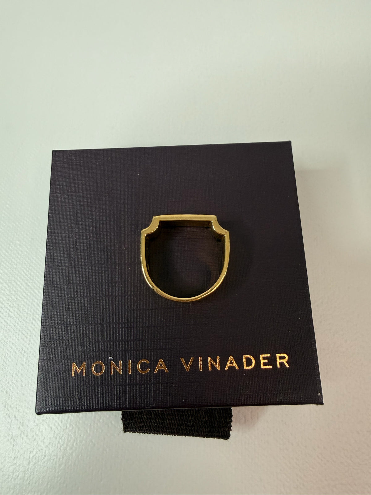 Style Reset Monica Vinader gold-tone architectural signet ring resting on a branded black jewellery box