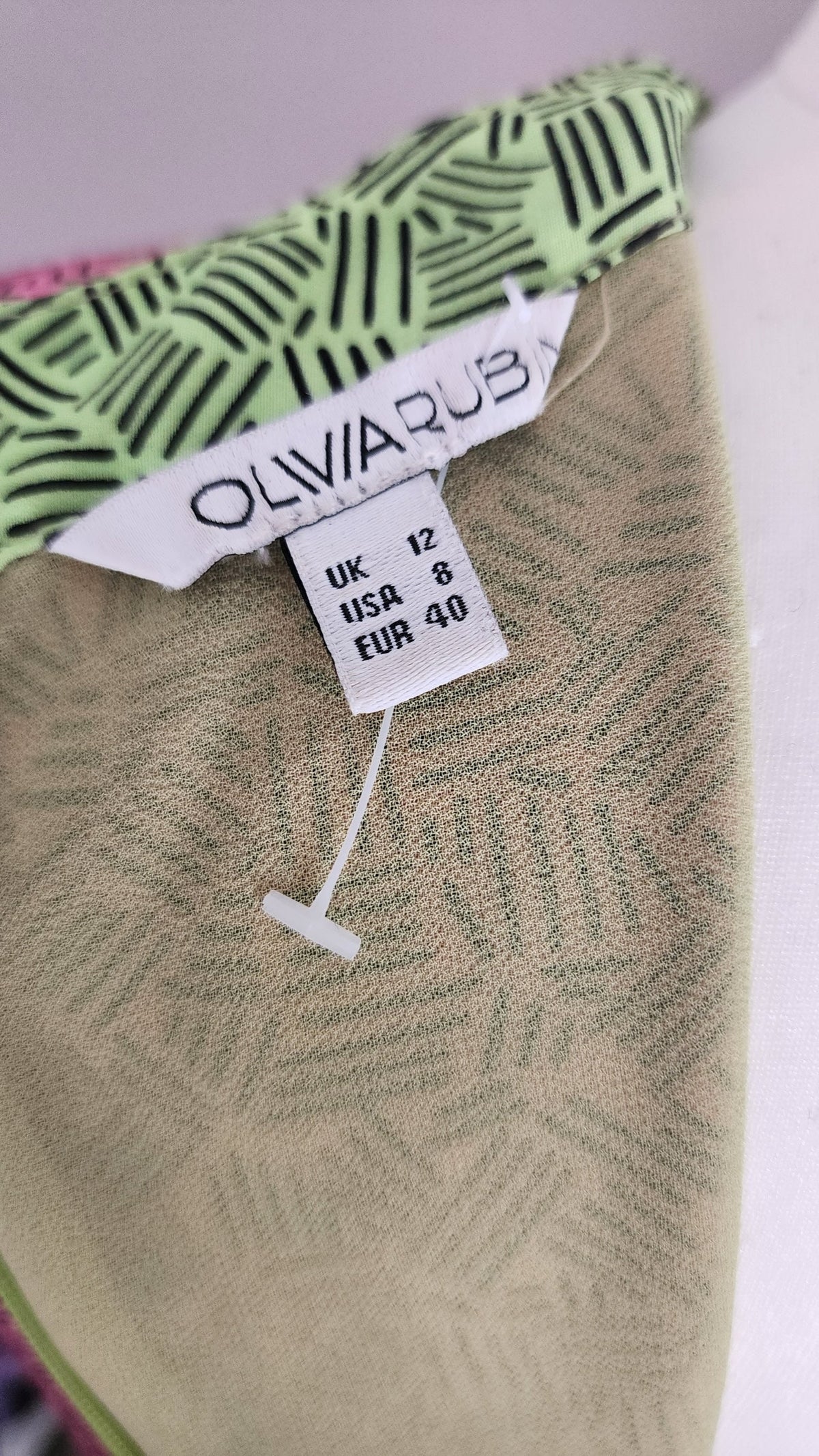 Style Reset OLIVARUB silk dress label showing UK size 12, USA size 8, and EUR size 40 with green geometric print
