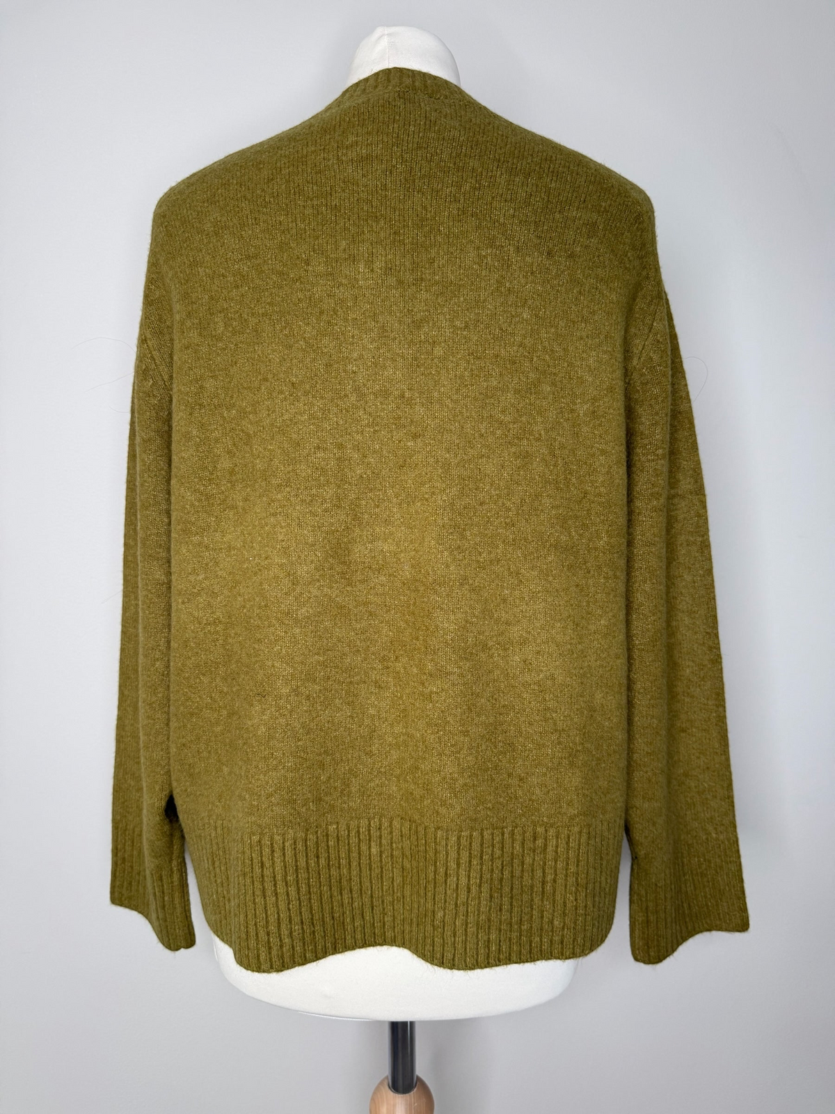Style Reset olive green long sleeve knit jumper with ribbed hem and cuffs shown from the back on a mannequin