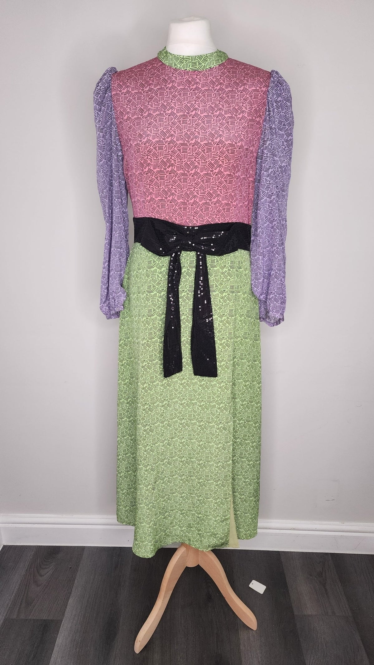 Style Reset Olivia Rubin silk midi dress with pink, lime green, and purple geometric print and black sequin waist belt.
