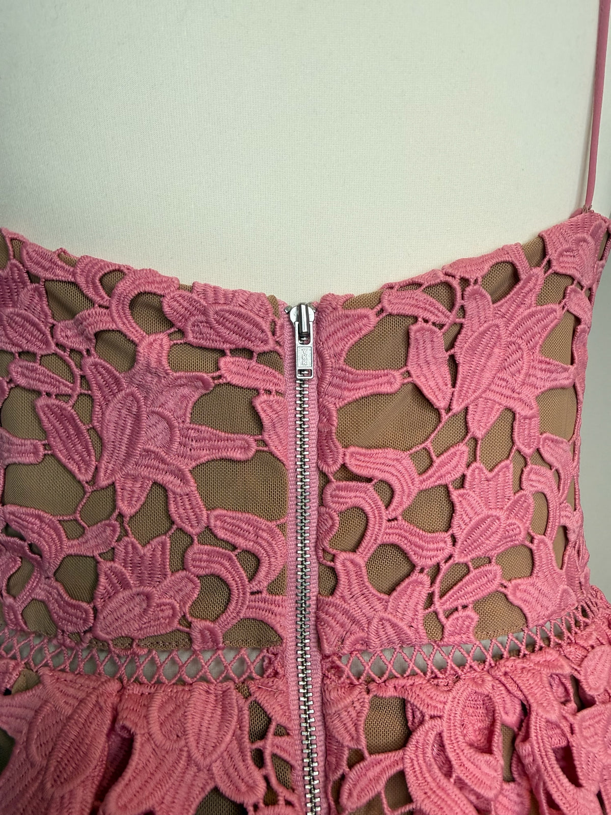 Style Reset pink floral lace midi dress back view featuring a silver zip closure and ladder-stitch waist detail