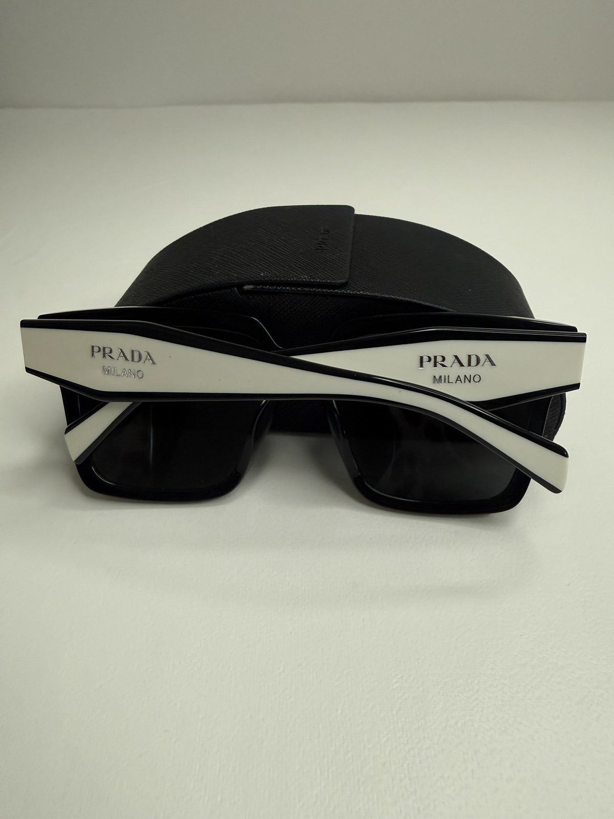 Style Reset Prada square frame sunglasses in black acetate with white temple logo detailing and Saffiano case