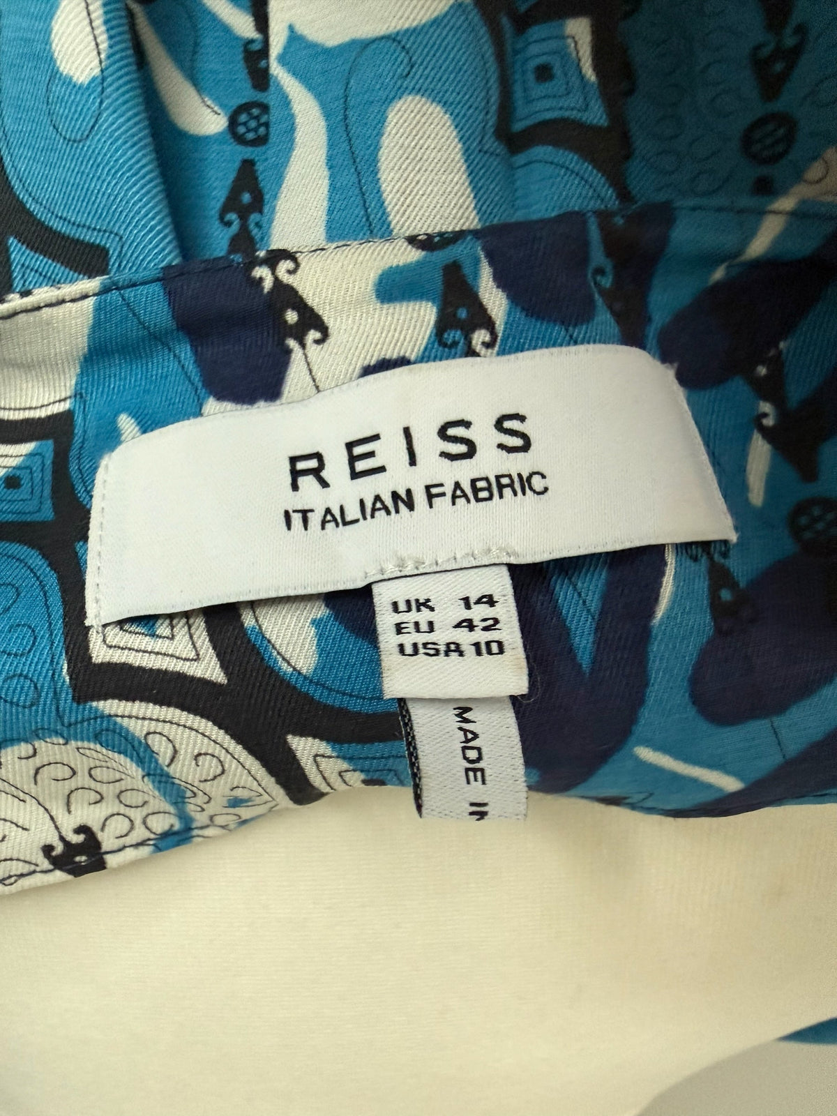 Style Reset REISS dress label showing Italian fabric and size 14 against a blue and white geometric floral print