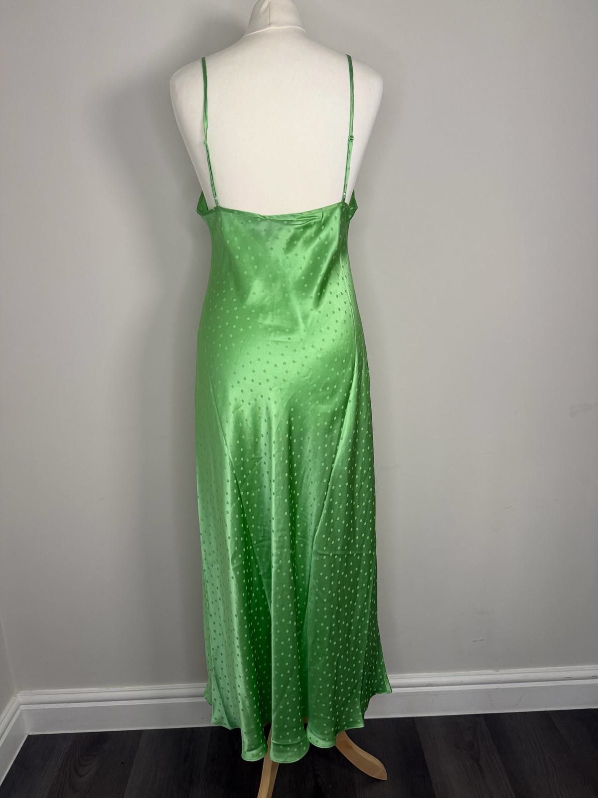 Style Reset RIXO green silk slip maxi dress with tonal polka dot jacquard pattern on a mannequin, back view.