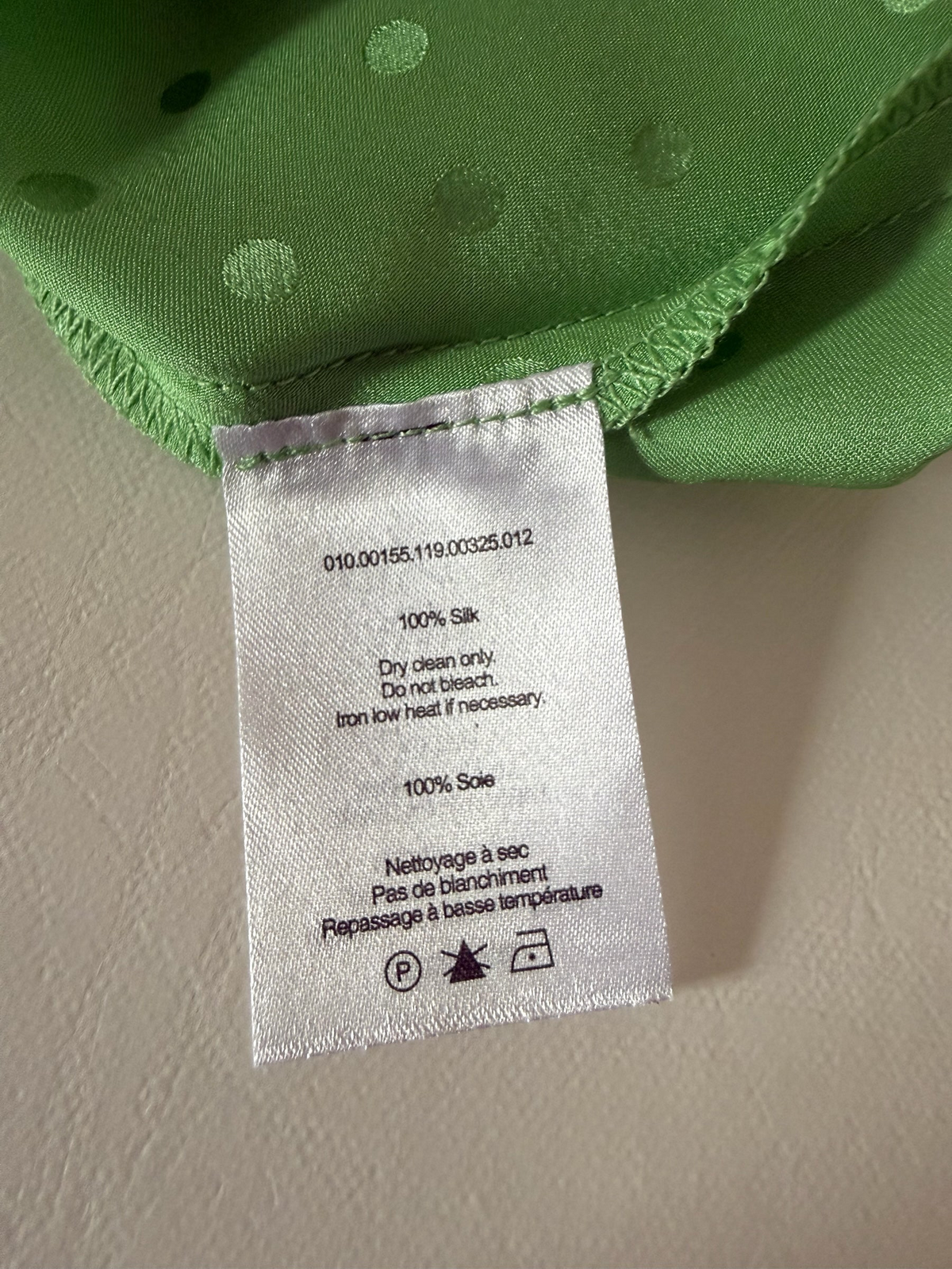 Style Reset RIXO green silk slip dress care label showing 100% silk composition and dry clean instructions