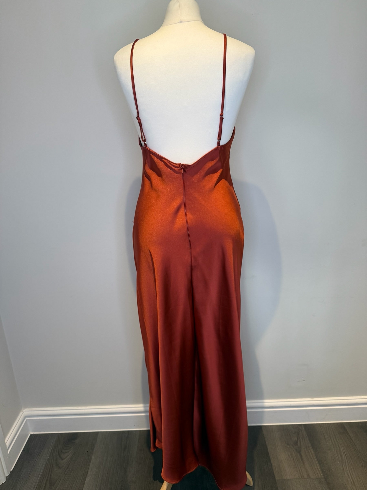 Style Reset rust-coloured satin maxi slip dress with spaghetti straps and back zip closure on a mannequin