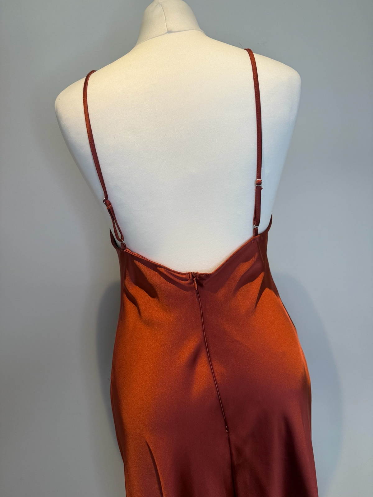 Style Reset rust-coloured satin maxi slip dress with adjustable spaghetti straps and back zip closure on a mannequin