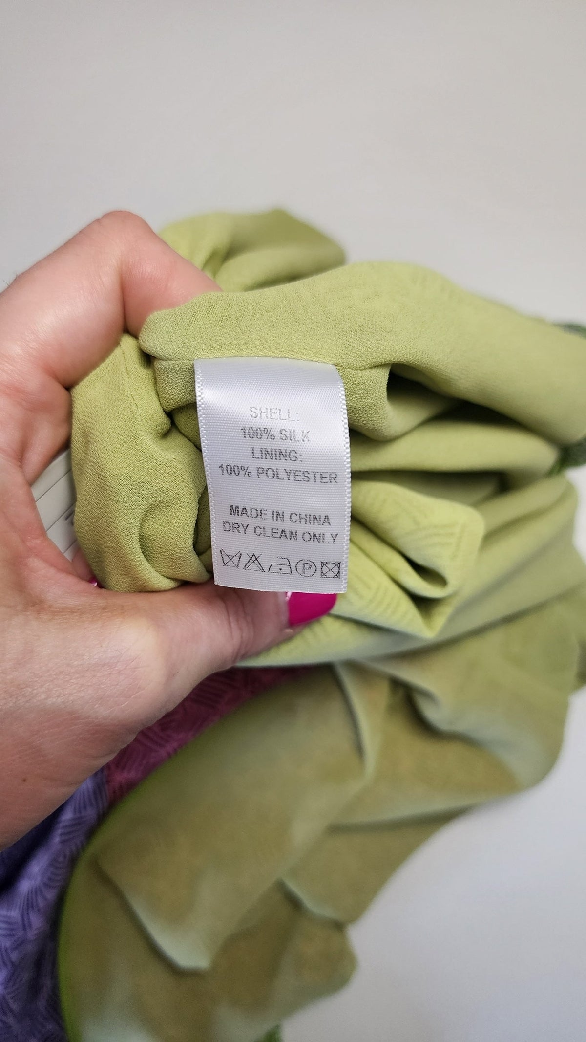 Style Reset Olivia Rubin silk dress care label showing 100% silk shell and 100% polyester lining composition