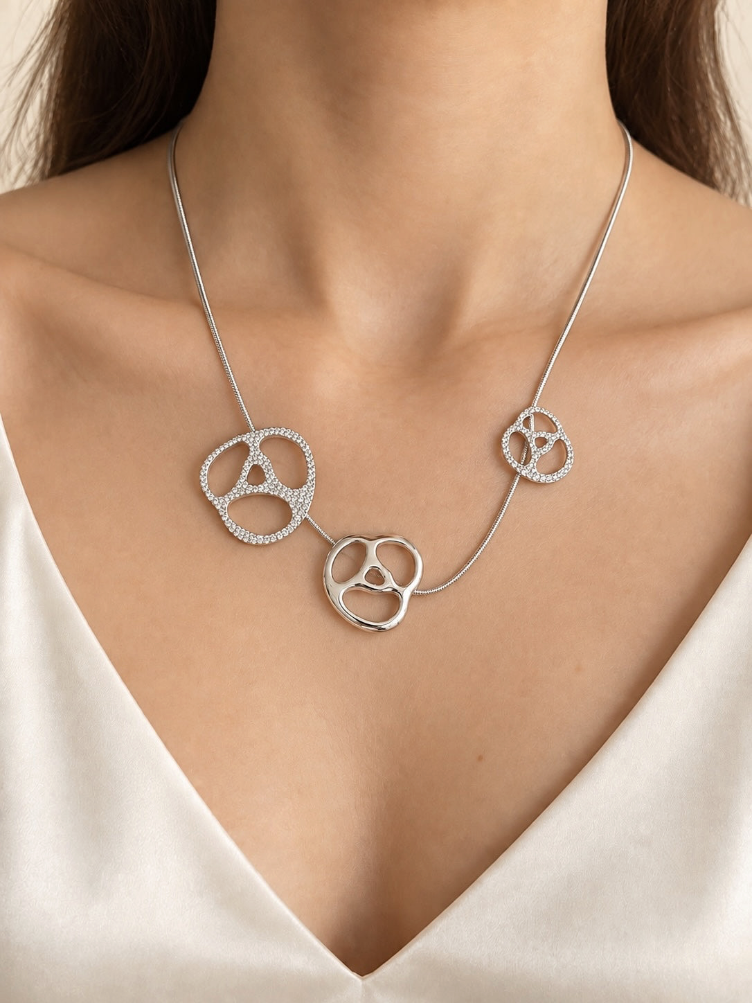 Style Reset Swarovski silver-tone statement necklace featuring three abstract organic pendants with pavé-set crystals.