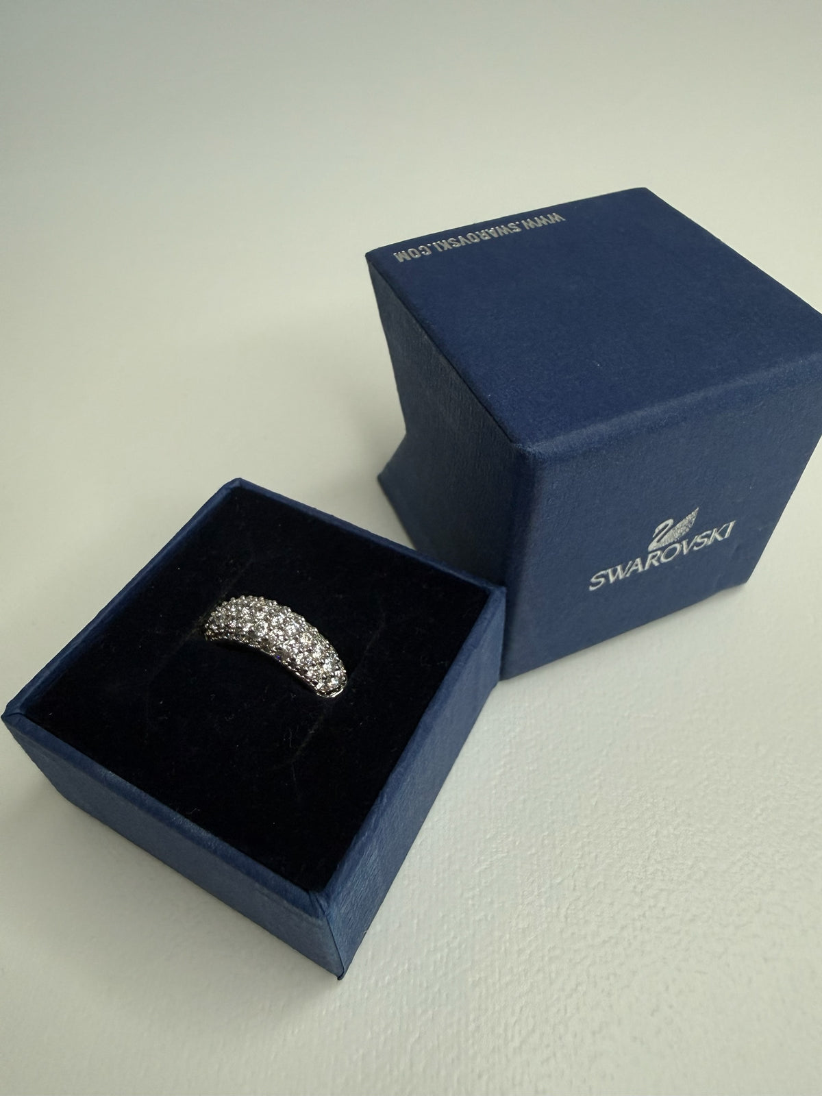 Style Reset Swarovski dome ring featuring dense pavé-set crystals in a silver-tone finish inside a blue gift box.