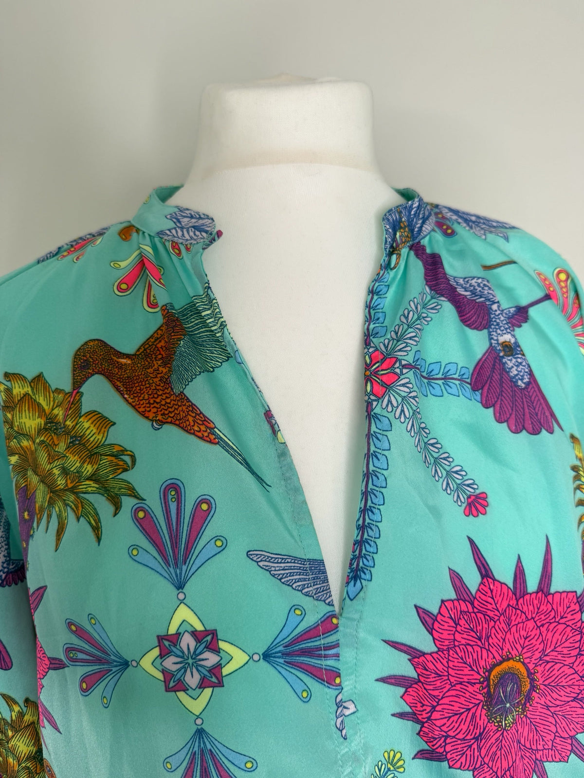 Style Reset turquoise maxi dress with a vibrant hummingbird and floral print, featuring a flattering V-neckline.