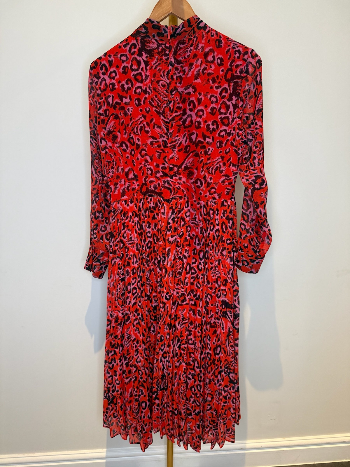 Style Reset Whistles long sleeve midi dress in a vibrant red and black animal print with a pleated skirt.