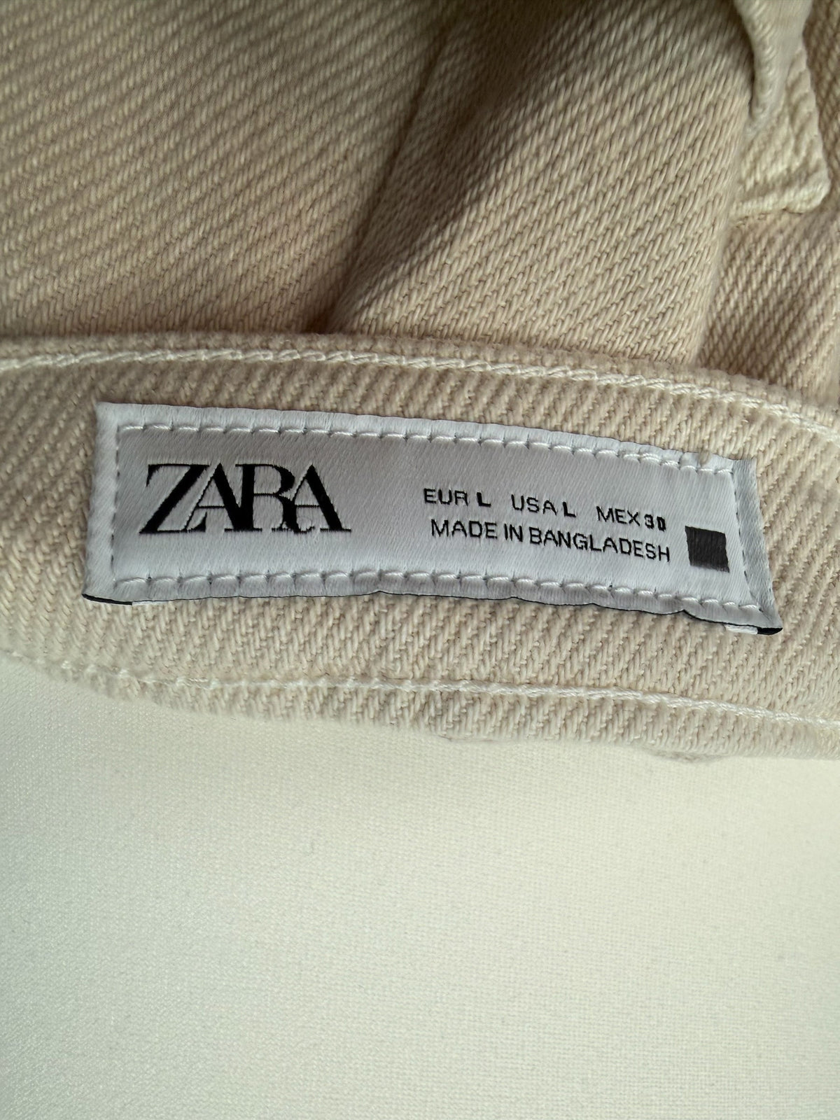 Style Reset ZARA beige cotton denim skirt label showing size L and country of origin
