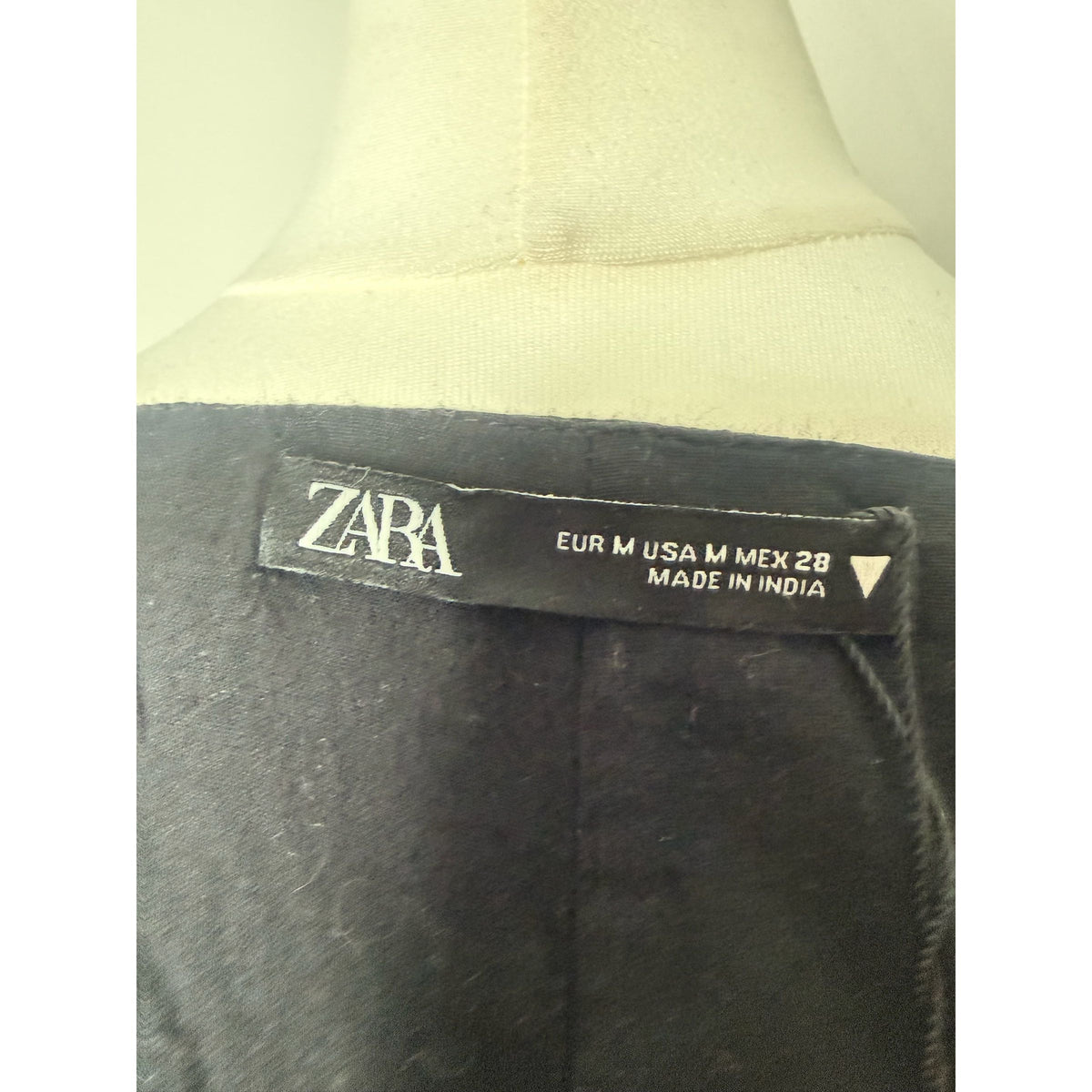 Style Reset ZARA black embroidered mini dress brand label showing size M and origin on a mannequin