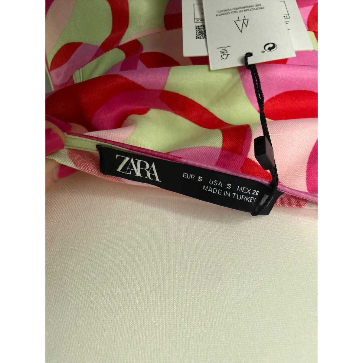 Style Reset Zara mini dress featuring a pink and sage green abstract colour block pattern with original tags attached