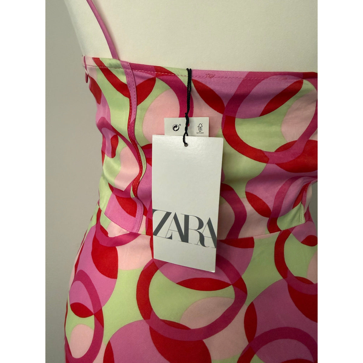 Style Reset Zara mini dress featuring a pink, red, and sage green circular pattern with original brand tags attached.