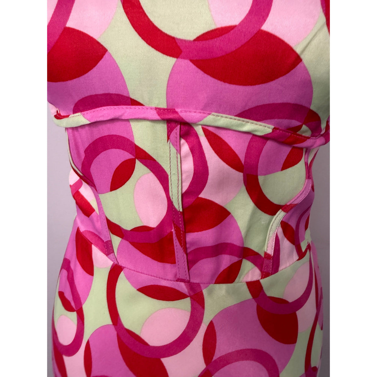Style Reset Zara mini dress featuring a pink and sage green geometric circle print with a fitted corset-style waist.
