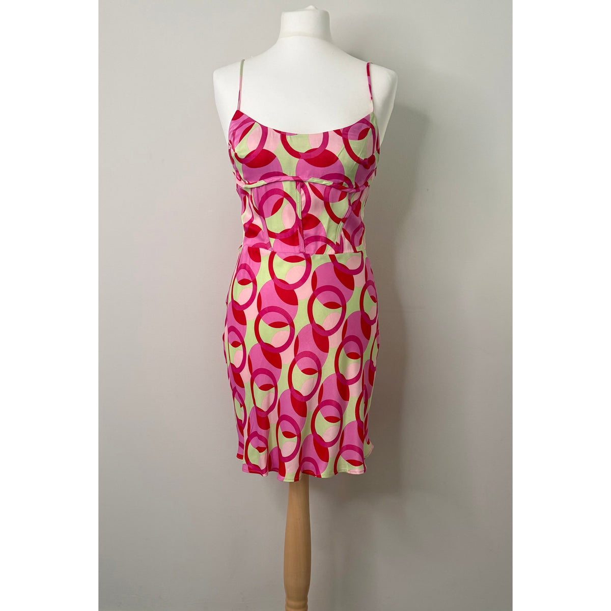 Style Reset Zara mini dress featuring a pink and sage green circular pattern on a fitted sleeveless silhouette