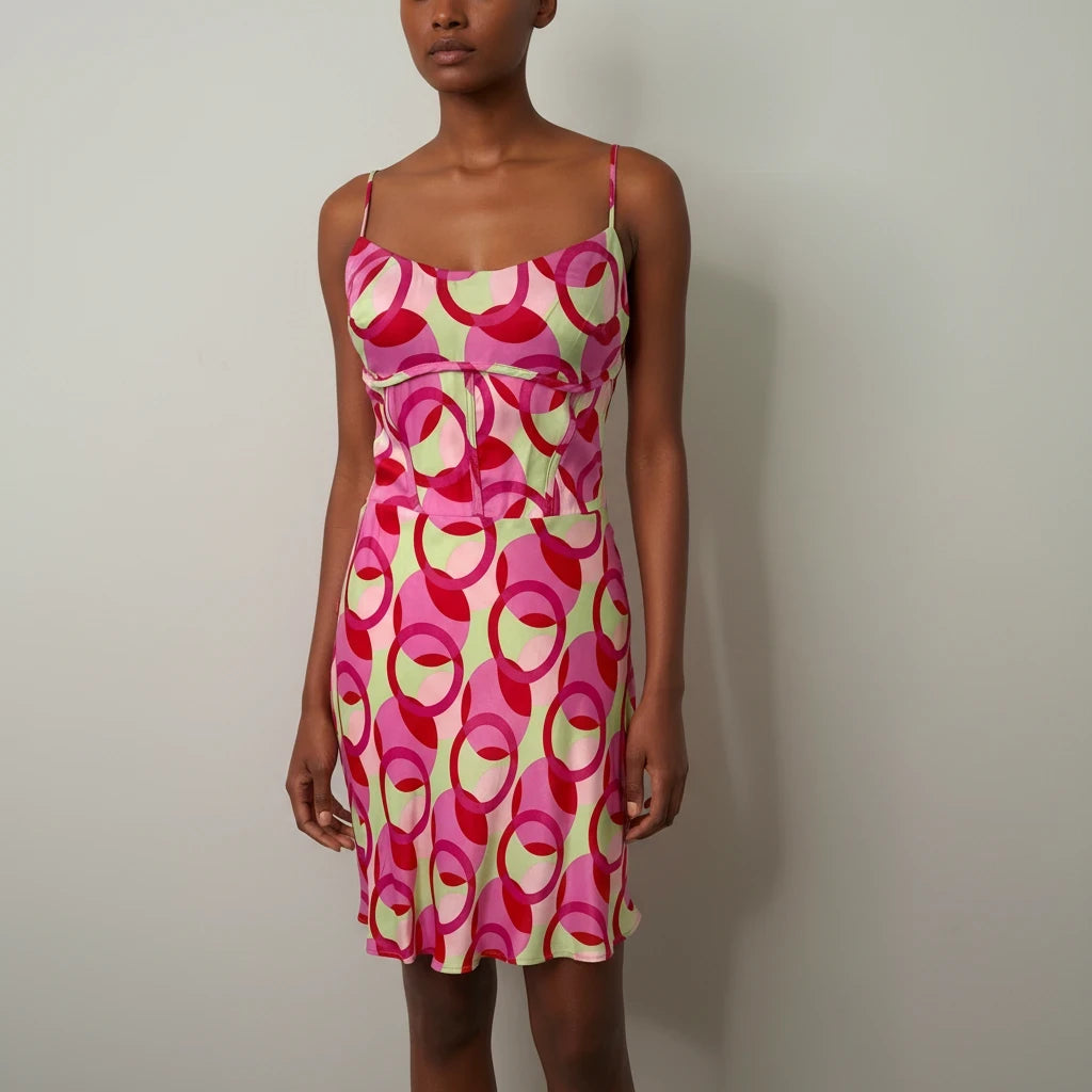 Style Reset Zara mini dress featuring a pink and sage green circular pattern with a fitted bodice and spaghetti straps